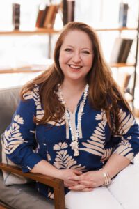 Siobhan Casey, founder and interior designer at Casey & Fox, seated in a relaxed interior setting.
