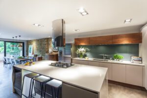 Contemporary open-plan Kingston kitchen and dining room designed by Casey & Fox, featuring bespoke cabinetry, statement lighting and layered natural materials.